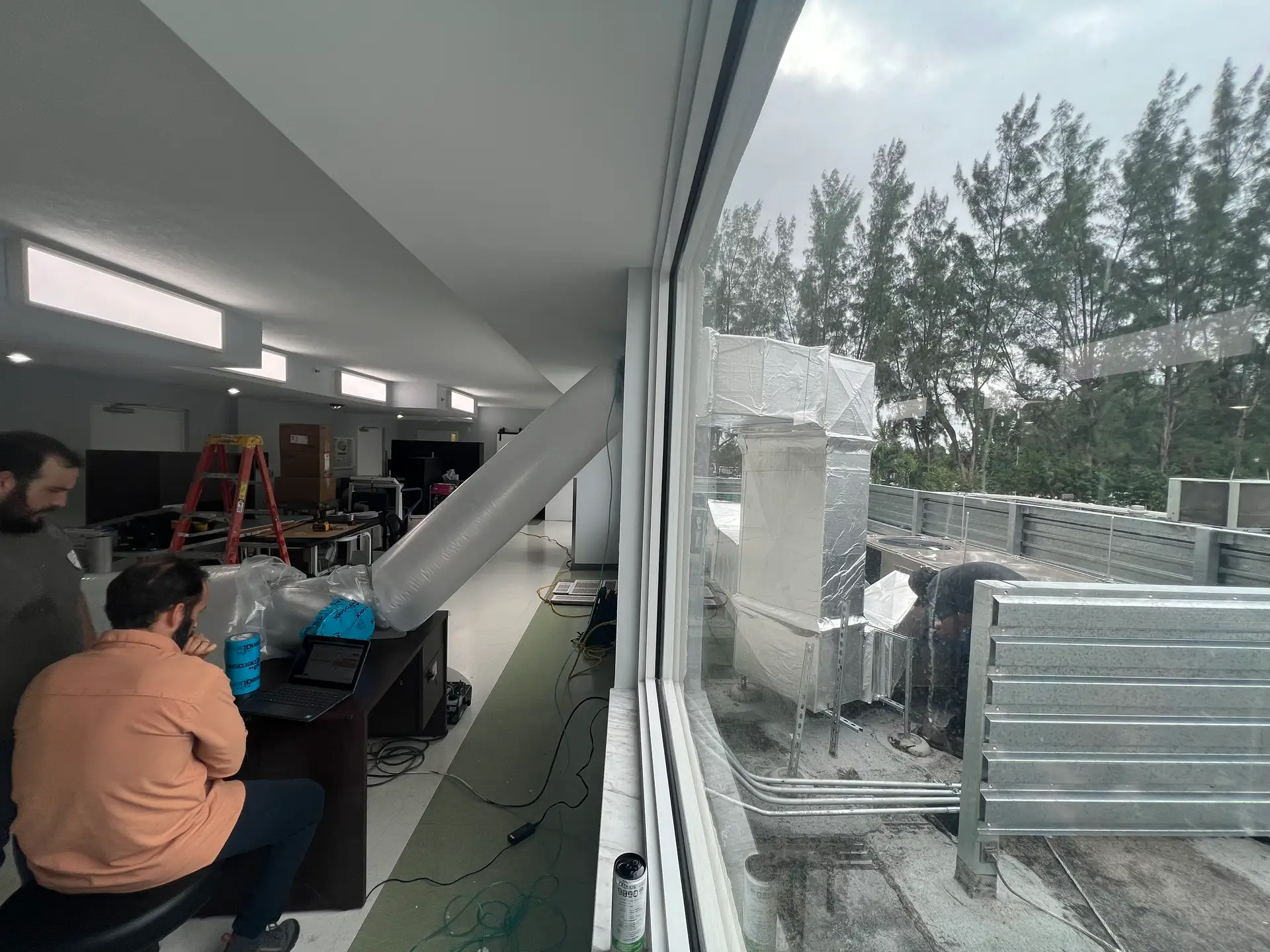 Clean Air Miami Aeroseal team performing duct sealing service inside and outside South Florida home